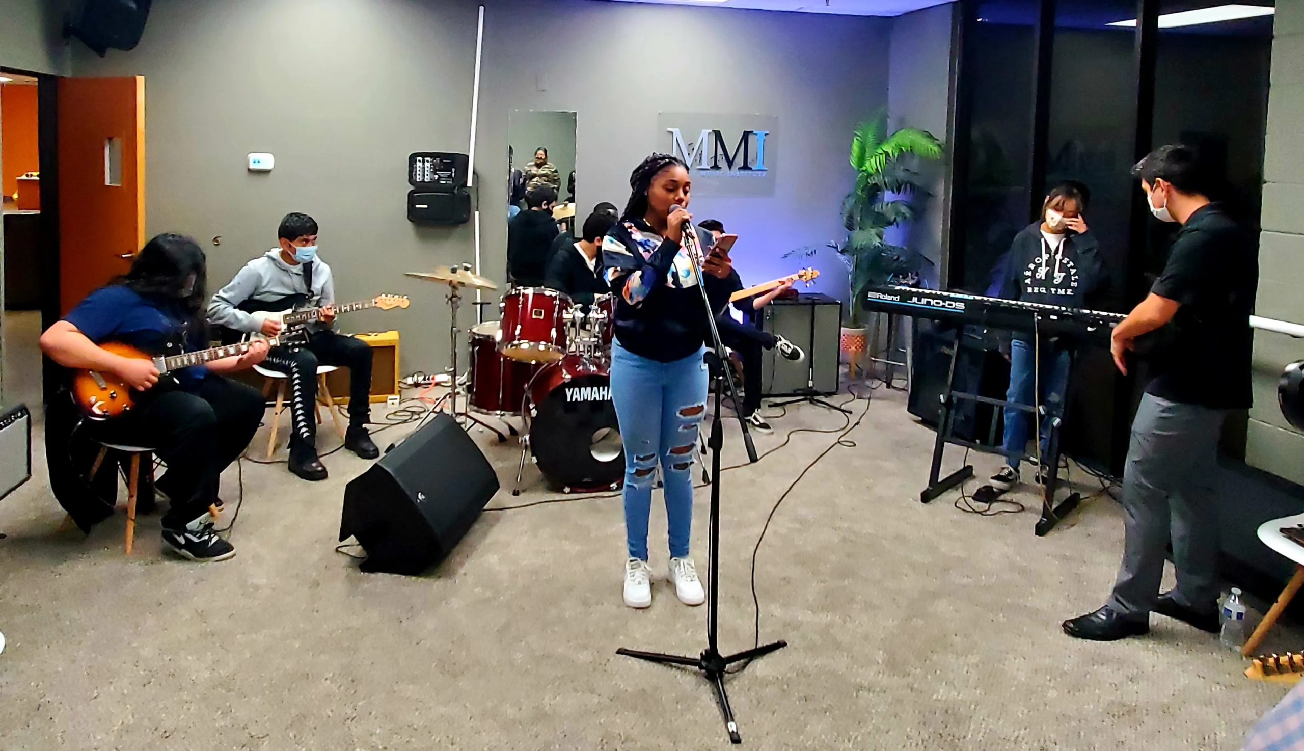 Students rehearse as a band in the studio, showing what a hands-on music nonprofit can make possible.