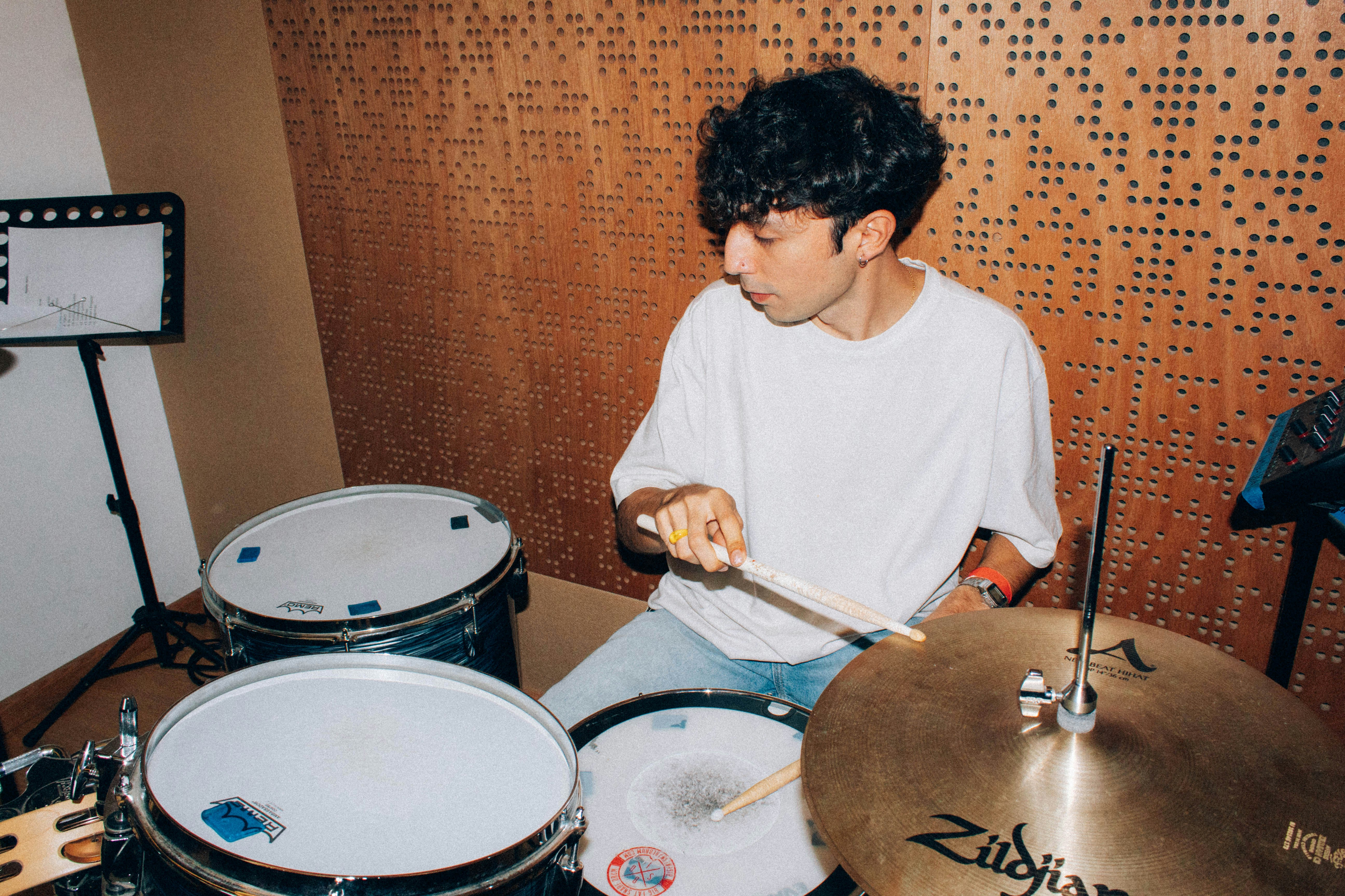 Student musician seated at a drum kit in a hands-on program built to support music education access.